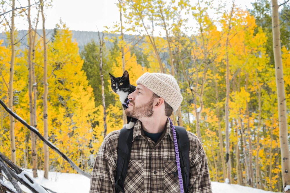man enjoying hike with cat